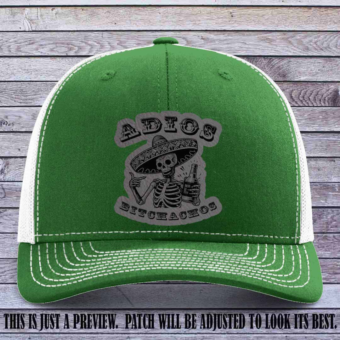 Grey leather patch on Kelly to White Richardson 112 trucker hat featuring “Adios Bitchachos” skeleton design.