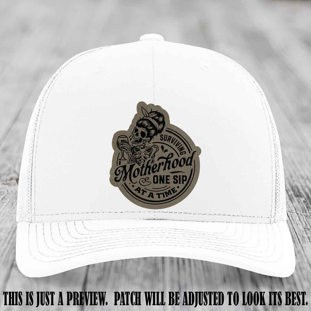 Surviving Motherhood One Sip at a Time Light Brown to Black Patch on Richardson 112 Hat - White Hat