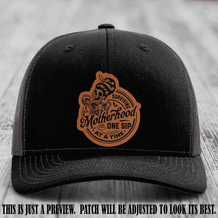 Surviving Motherhood One Sip at a Time Rawhide to Black Patch on Richardson 112 Hat - Black to Charcoal Hat