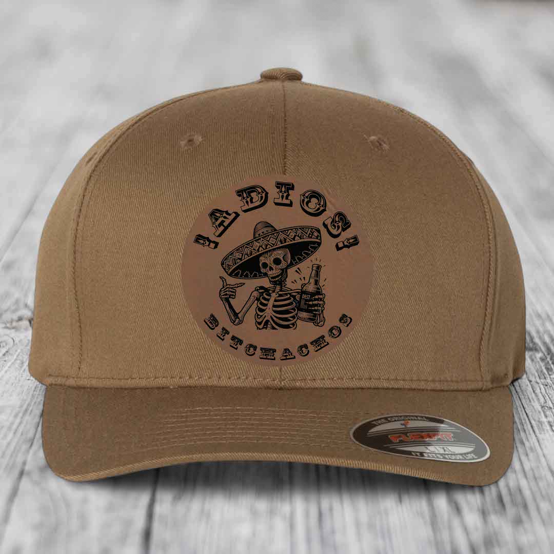 Tan baseball cap with black skeleton wearing sombrero holding beer bottle, text reads &