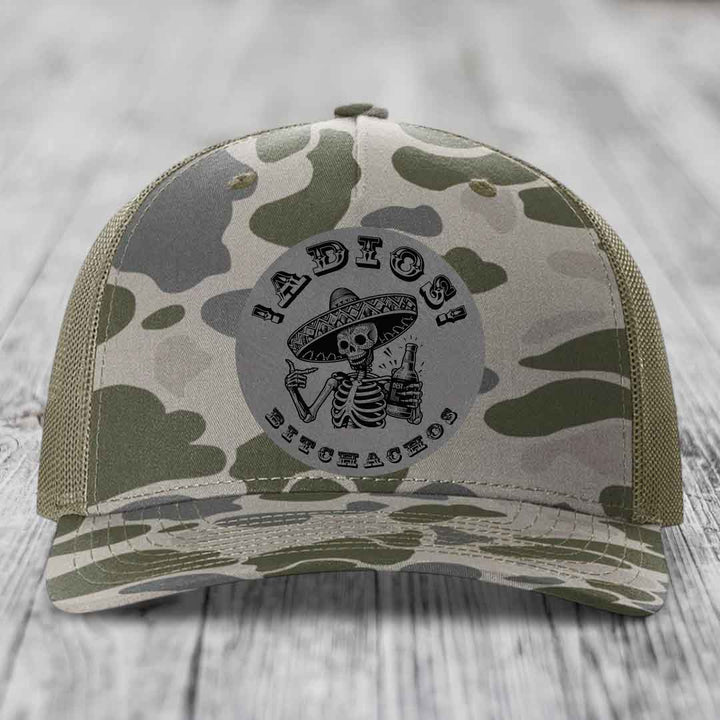 Camouflage trucker hat with skeleton in sombrero patch reading &