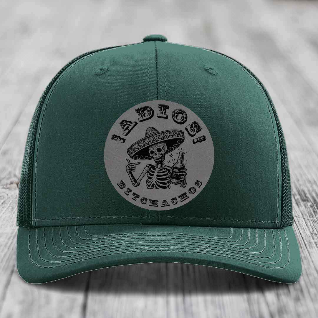 Green trucker hat with a circular patch featuring a skeleton in a sombrero holding a beer bottle, text reads &