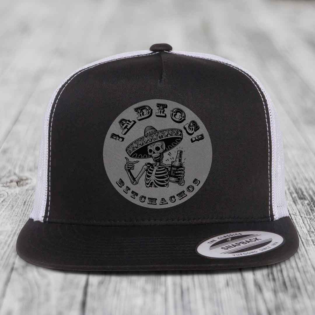 Black and white trucker hat with skeleton wearing sombrero holding beer bottle, text &