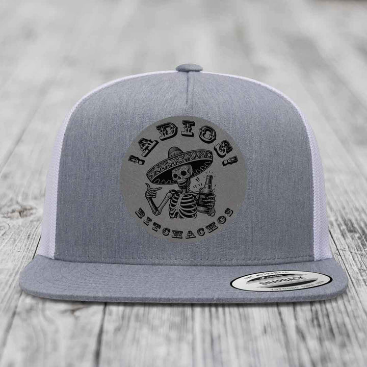 Grey trucker hat with black skeleton graphic holding beer and wearing sombrero, text reads &