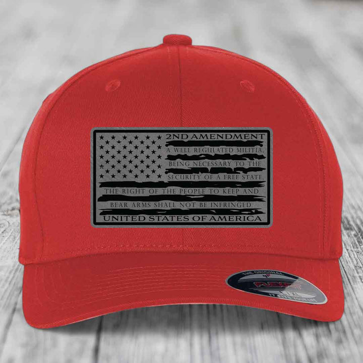 Red baseball cap with black 2nd Amendment patch featuring American flag design and text.