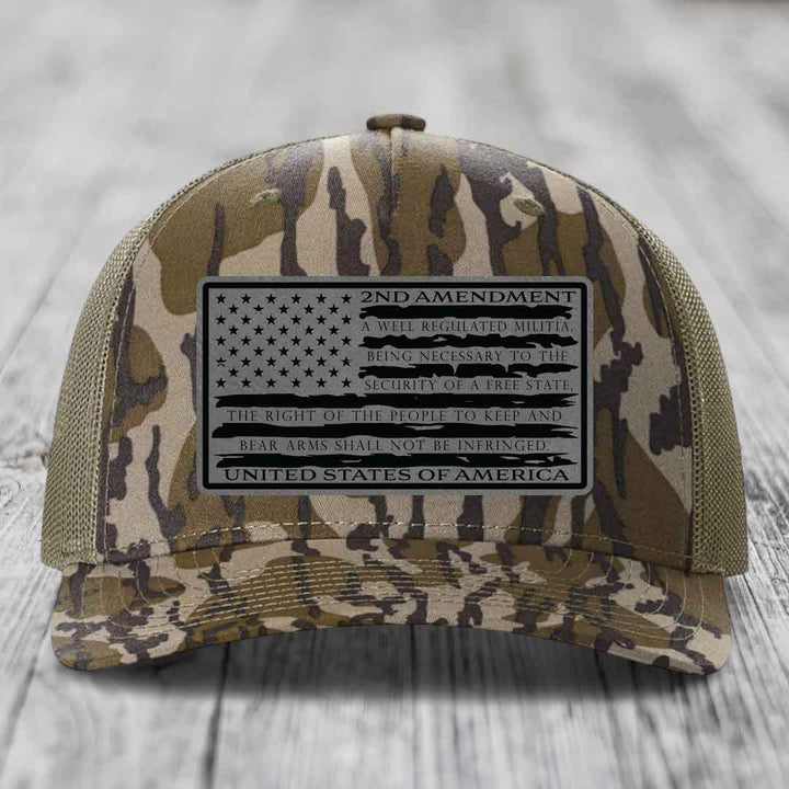 Camouflage trucker hat with a black 2nd Amendment patch featuring the American flag and text.