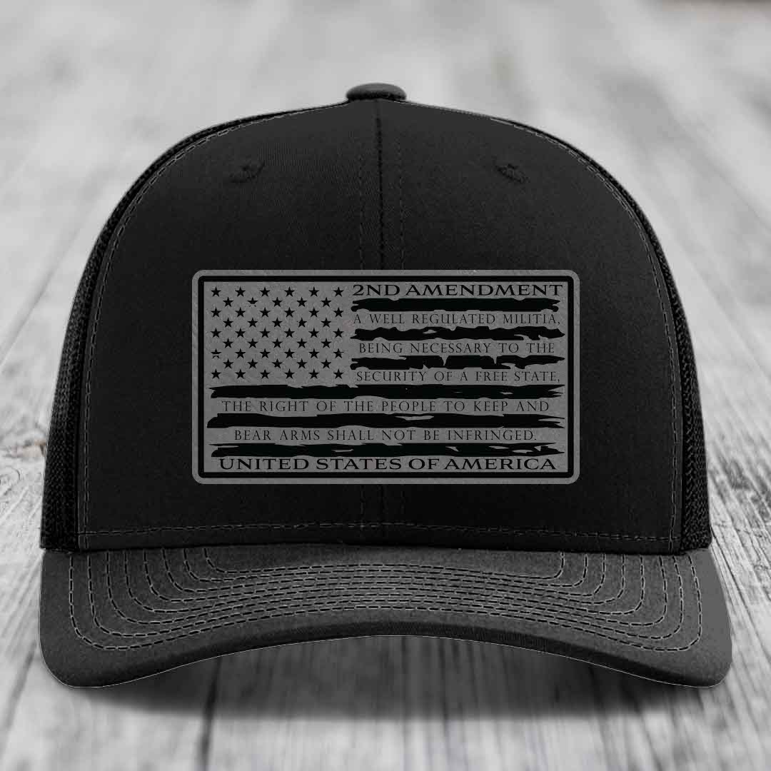 Black trucker hat with a rectangular patch featuring the American flag and 2nd Amendment text.