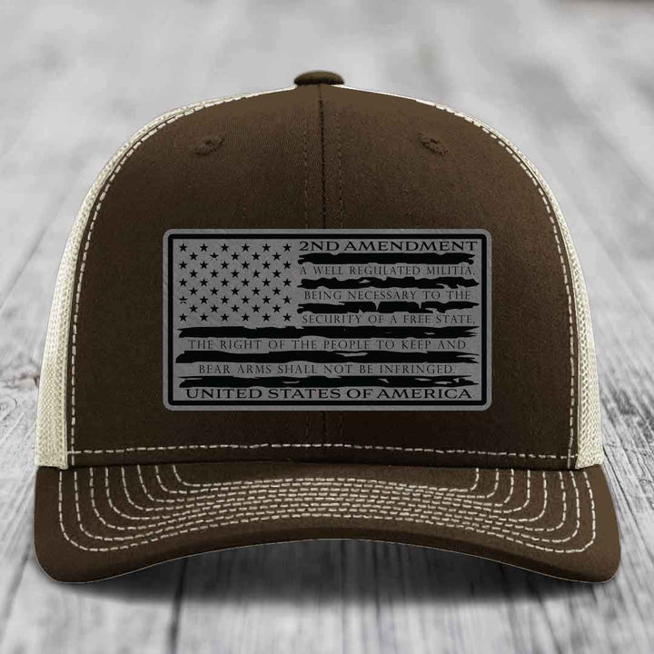 Brown trucker hat with white stitching and a black 2nd Amendment patch featuring the American flag design.