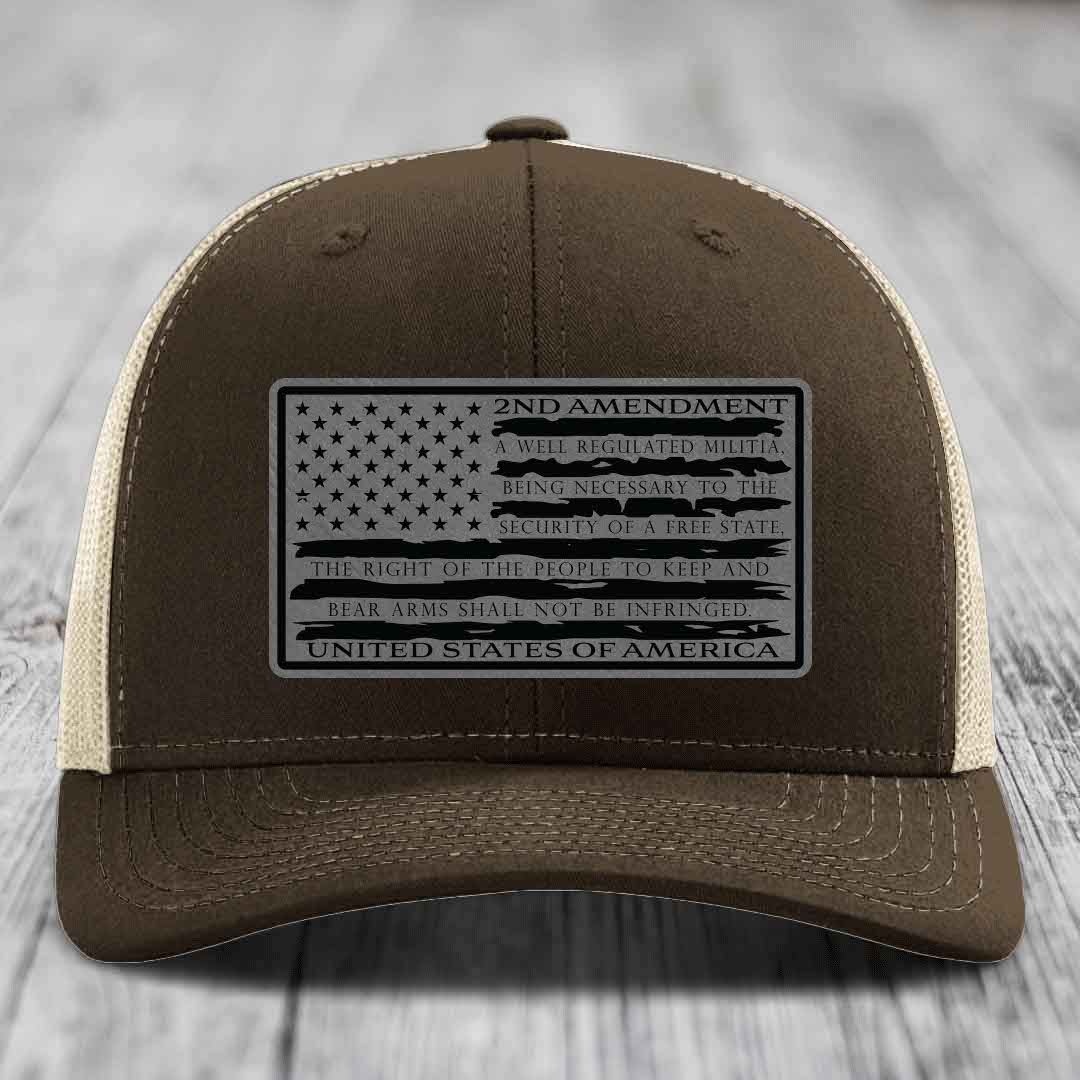 Brown trucker hat with black 2nd Amendment patch featuring American flag design and text.