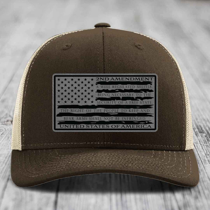 Brown trucker hat with black 2nd Amendment patch featuring American flag design and text.