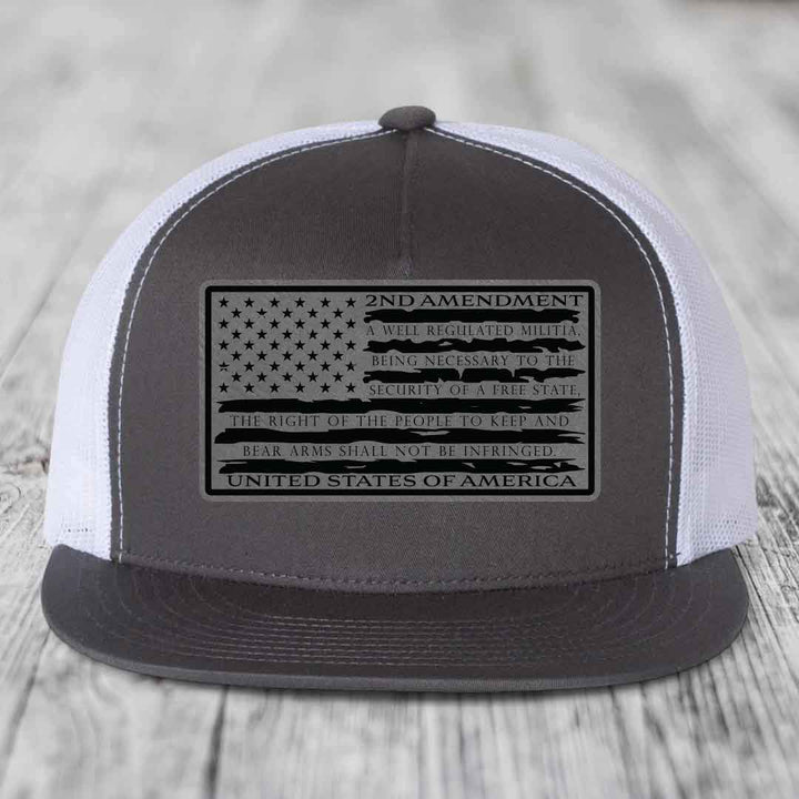 Grey and white trucker hat with black 2nd Amendment patch featuring American flag design.