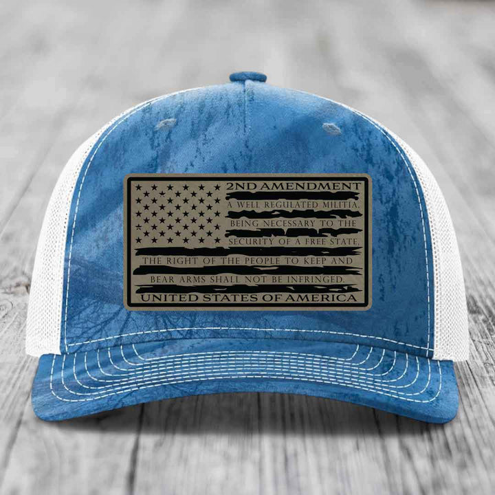 Blue and white trucker hat with a 2nd Amendment leather patch featuring the U.S. flag design.