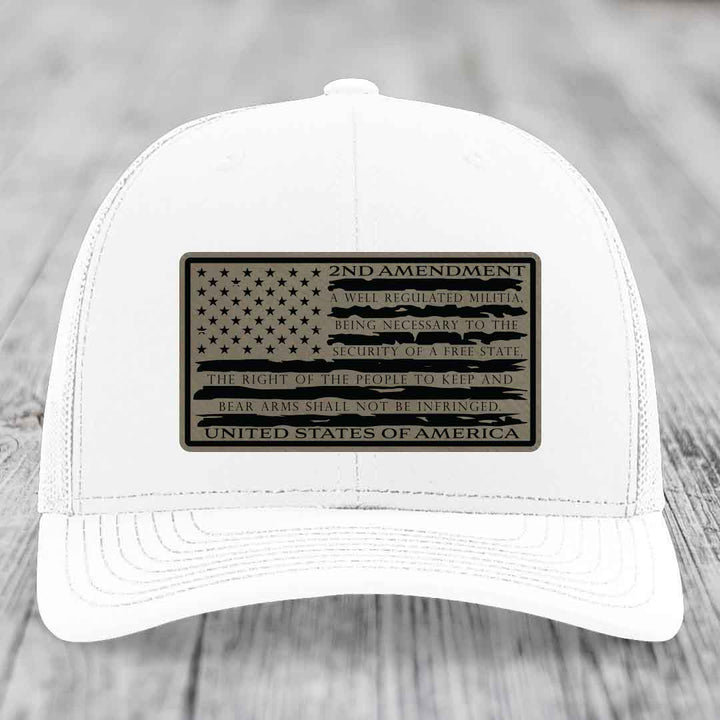 White trucker hat with a rectangular patch featuring the 2nd Amendment text and American flag design.