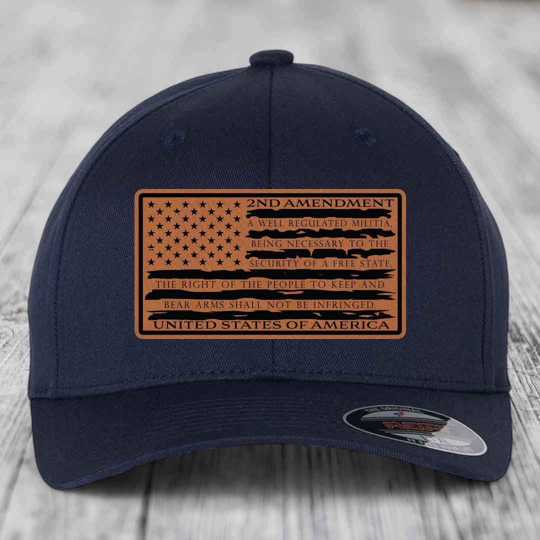 Dark blue baseball cap with a brown leatherette patch featuring the 2nd Amendment text and American flag design.