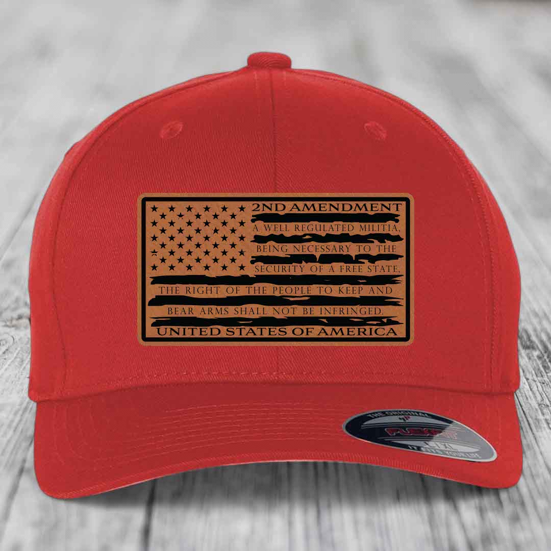 Red baseball cap with a tan leatherette patch featuring the American flag and 2nd Amendment text.
