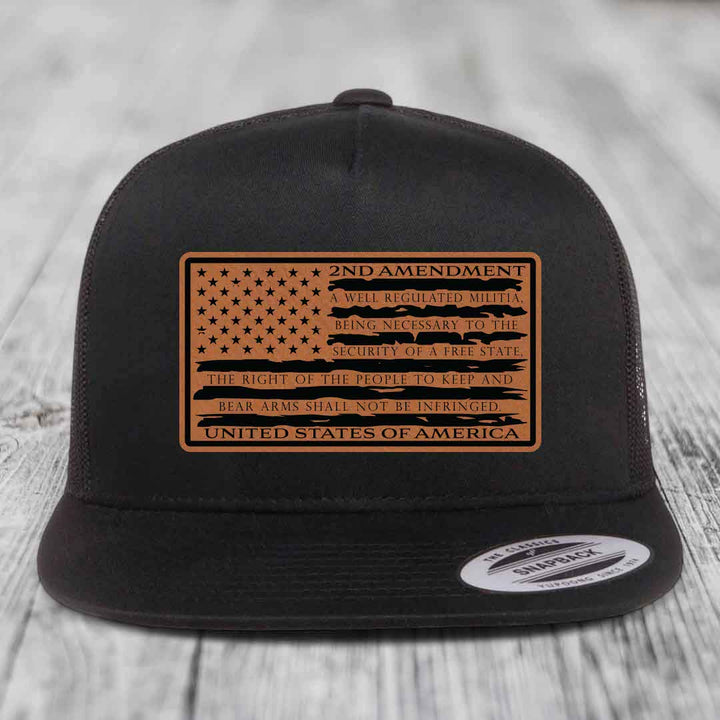 Black trucker hat with brown leather patch featuring American flag and 2nd Amendment text.