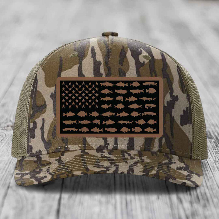 Camouflage trucker hat with American flag patch featuring fish silhouettes instead of stars and stripes.