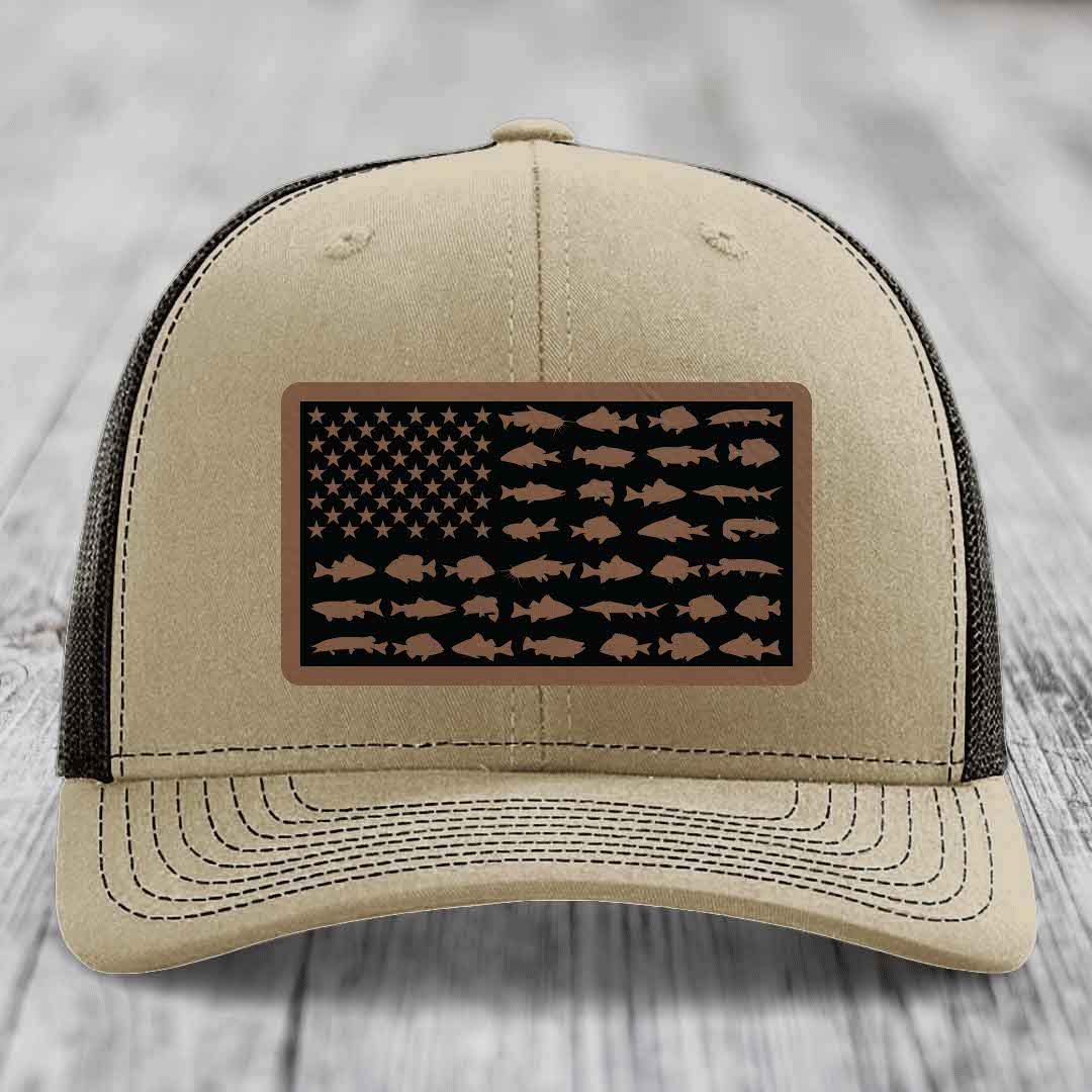 Beige trucker hat with American flag patch made of fish silhouettes in brown on black background.