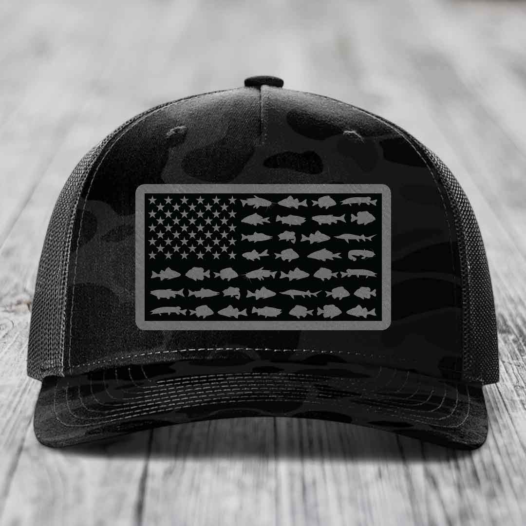 Black camouflage trucker hat with American flag patch made of fish silhouettes.