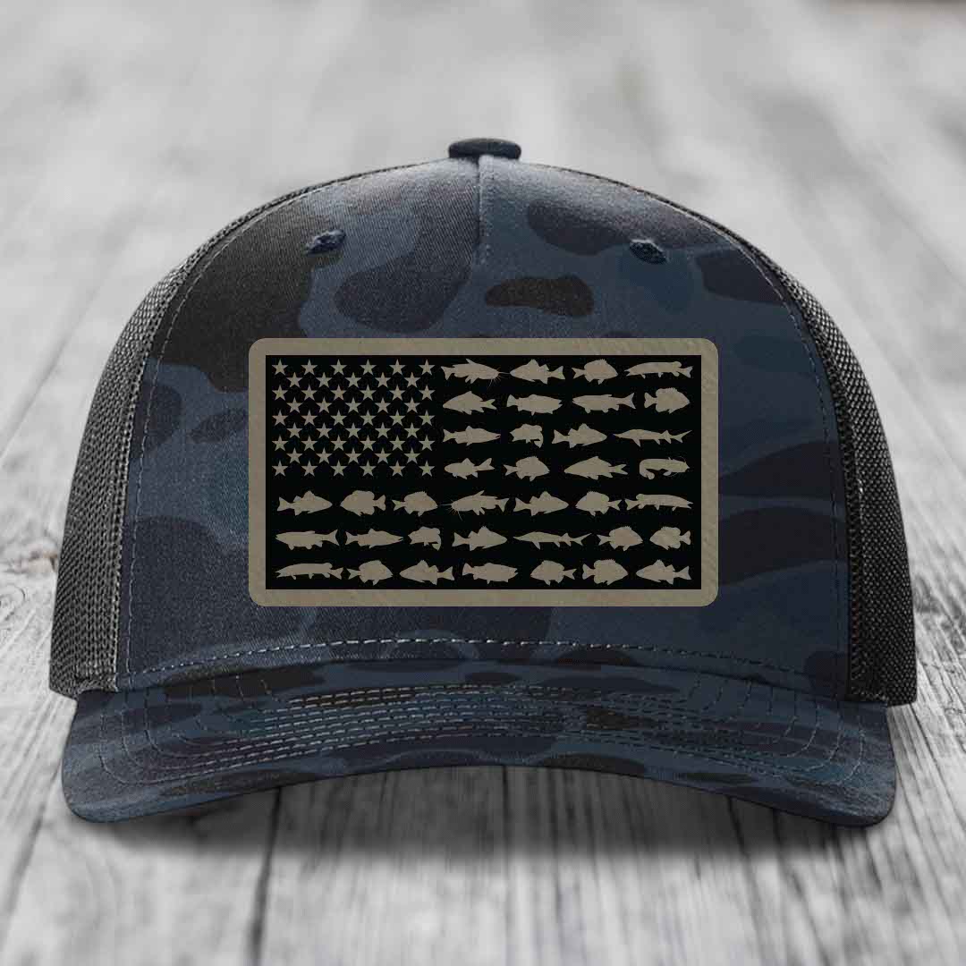 Camouflage trucker hat with American flag patch featuring fish silhouettes instead of stars and stripes.