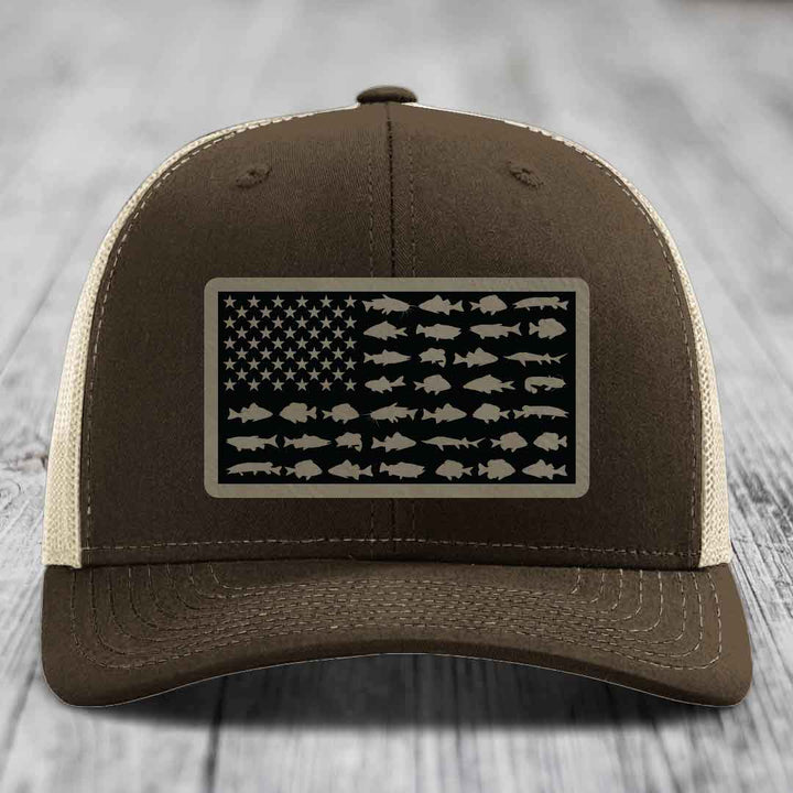 Brown trucker hat with American flag patch made of fish silhouettes.