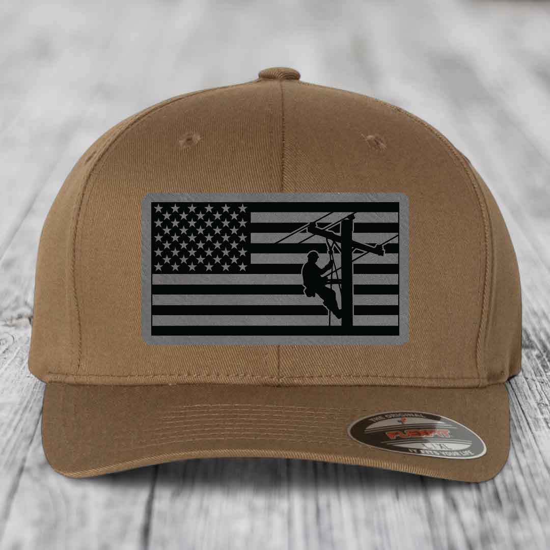 Tan baseball cap with American flag patch featuring lineman silhouette.