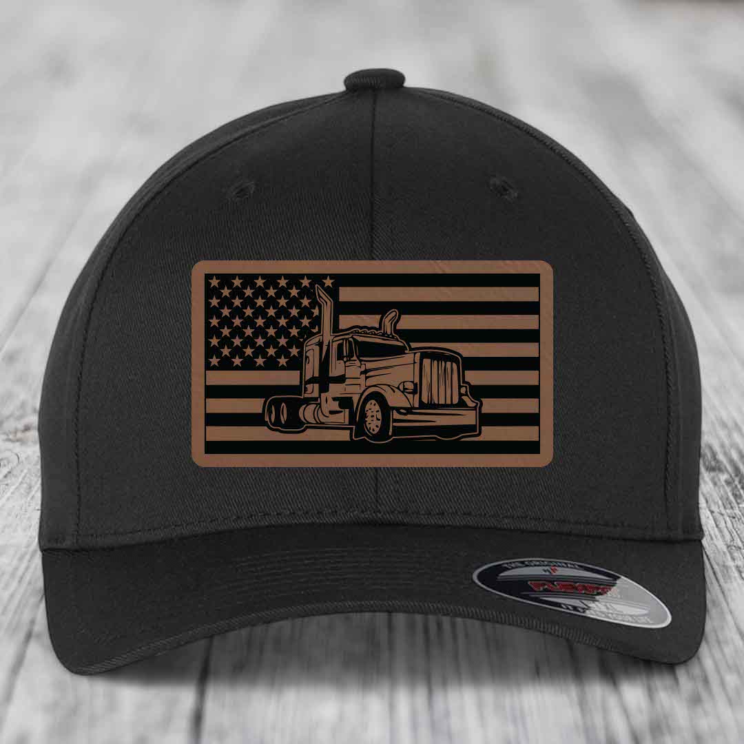 Black baseball cap with American flag patch featuring a Peterbilt truck silhouette.