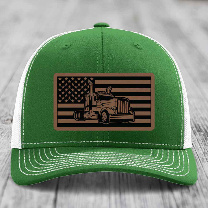 Green trucker hat with white mesh back and stitching, featuring a brown leatherette patch with American flag and Peterbilt truck design.