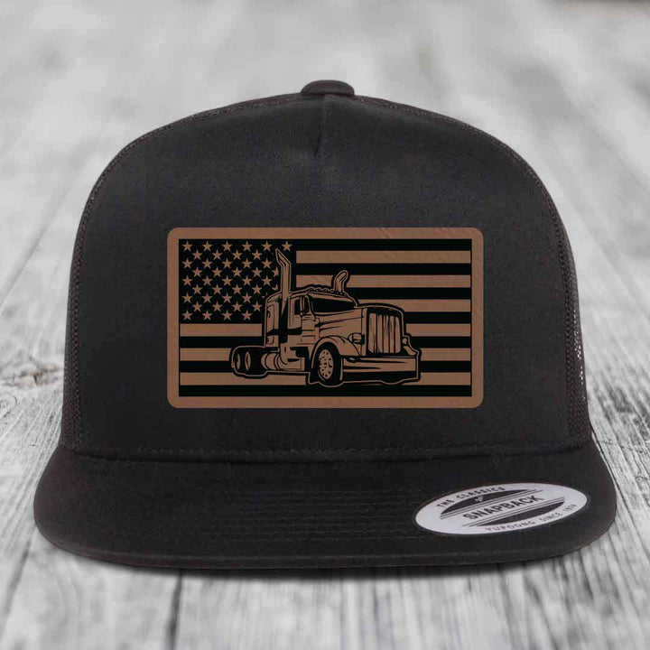 Black trucker hat with American flag patch featuring Peterbilt truck design.