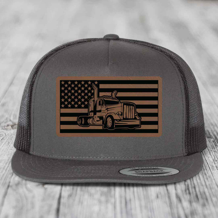 Grey trucker hat with American flag patch featuring a Peterbilt truck design.