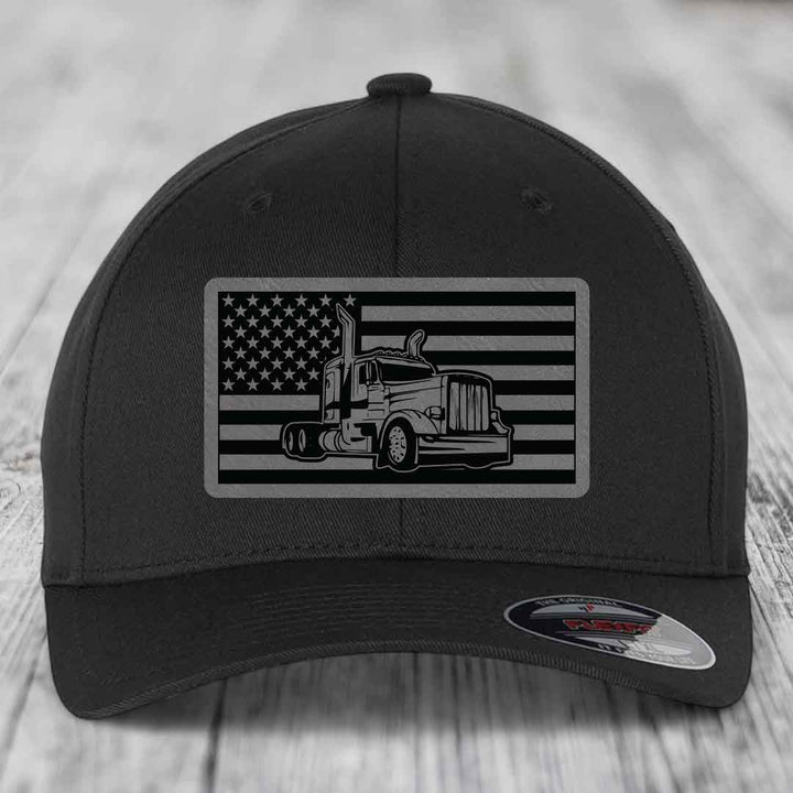 Black baseball cap with American flag patch featuring a Peterbilt truck silhouette.