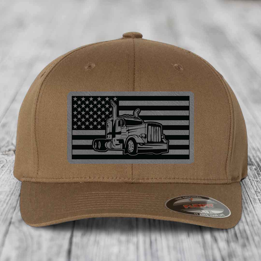Tan baseball cap with black and gray American flag patch featuring a Peterbilt truck silhouette.