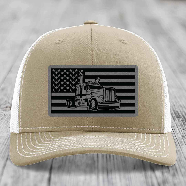 Tan trucker hat with black and gray American flag patch featuring a Peterbilt truck silhouette.
