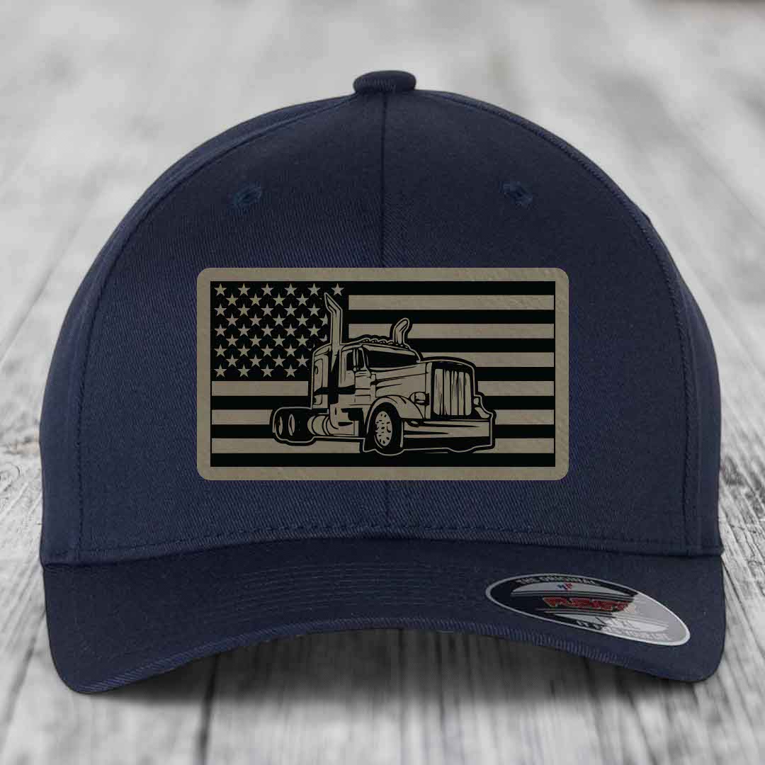 Dark blue baseball cap with American flag patch featuring a Peterbilt truck silhouette.