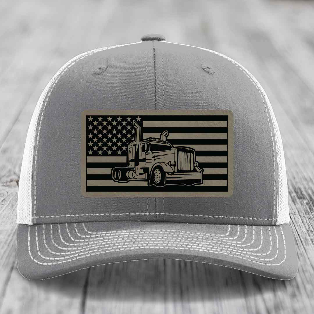 Grey trucker hat with American flag patch featuring Peterbilt truck design.