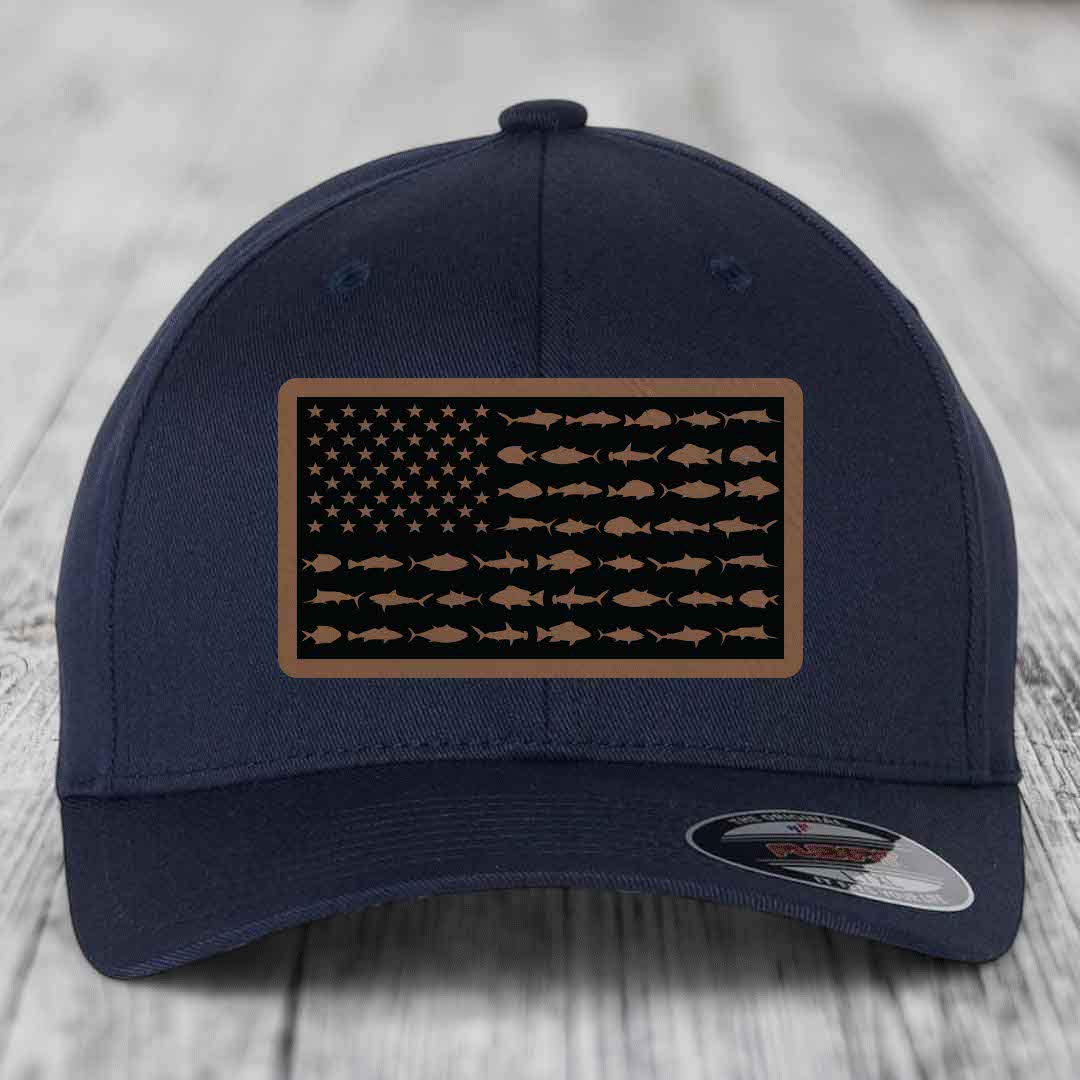 Dark blue baseball cap with a rectangular patch featuring an American flag design made of saltwater fish silhouettes.