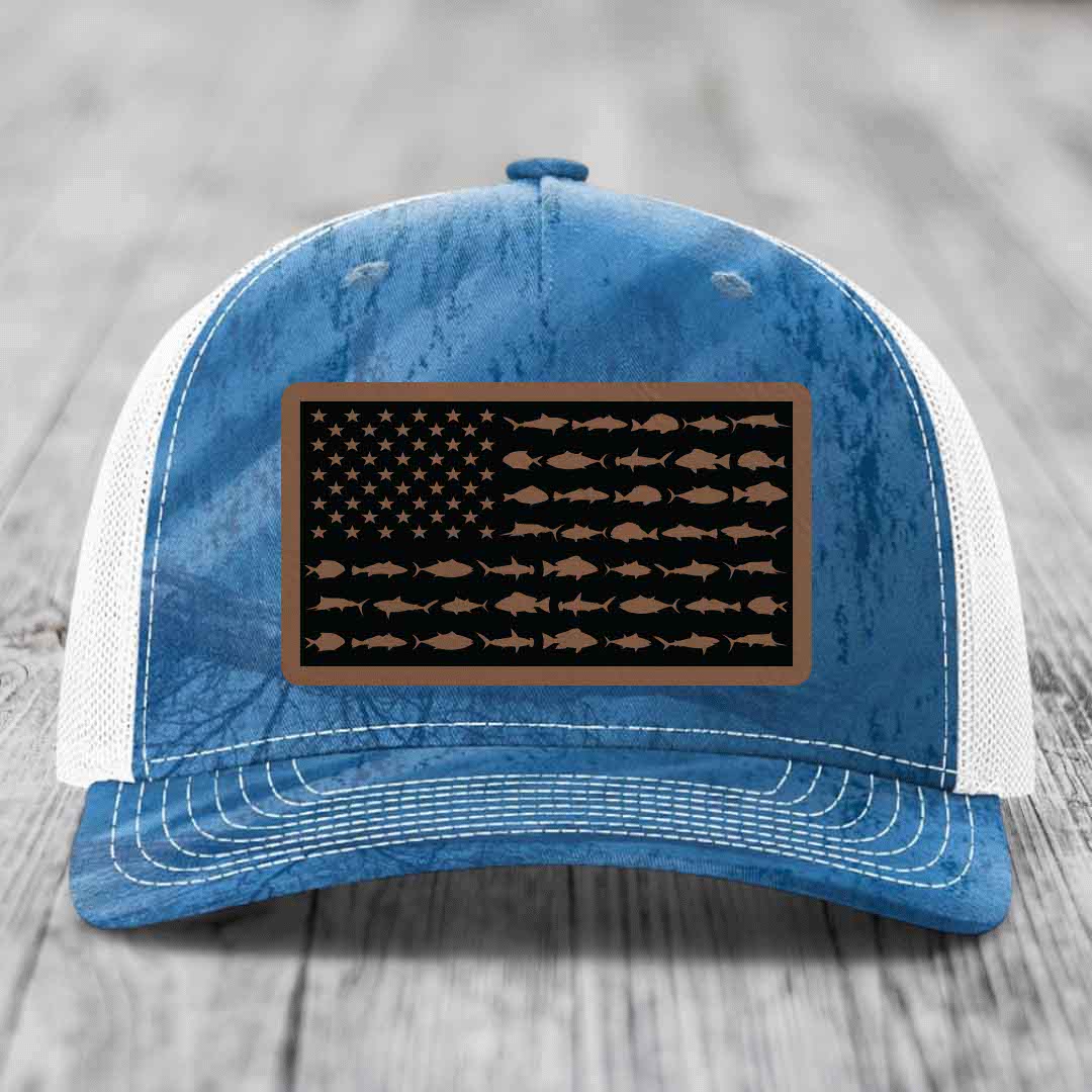 Blue and white trucker hat with a rectangular patch featuring an American flag design made of fish silhouettes.