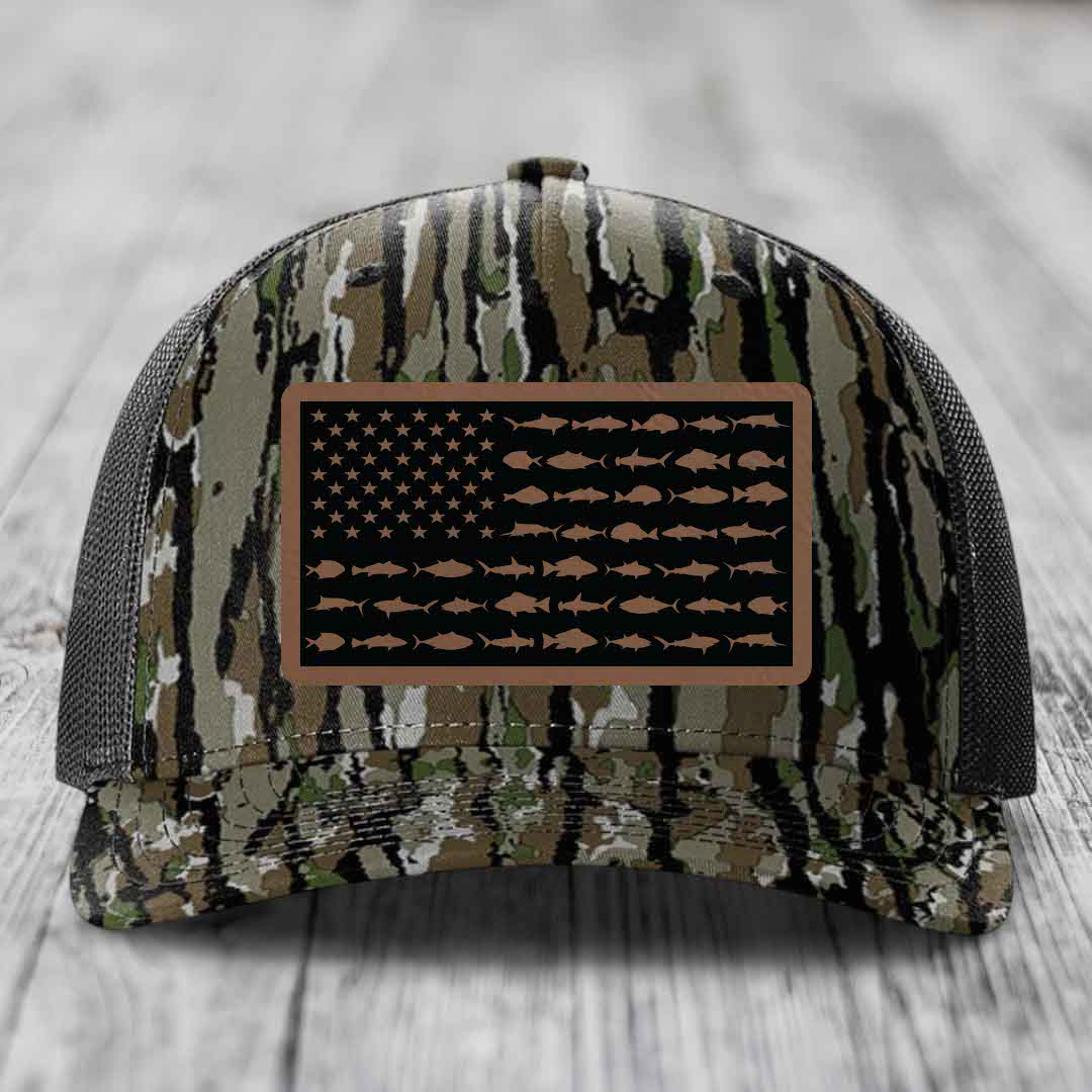 Camouflage trucker hat with American flag patch featuring fish silhouettes instead of stars and stripes.