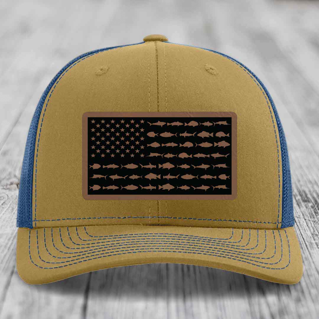 Tan and blue trucker hat with American flag patch made of saltwater fish silhouettes.