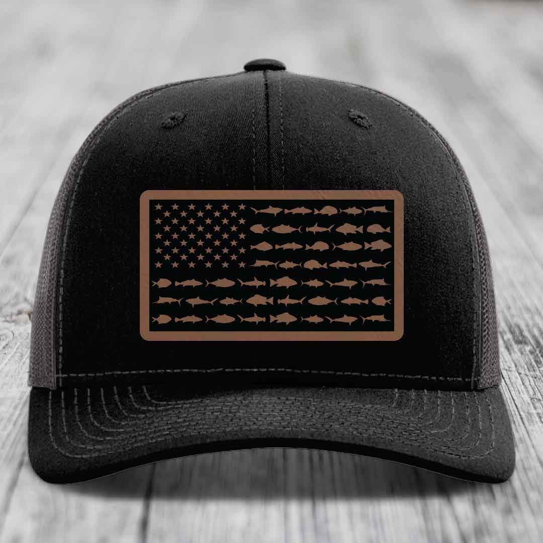 Black trucker hat with a rectangular patch featuring an American flag design made of fish silhouettes in brown.