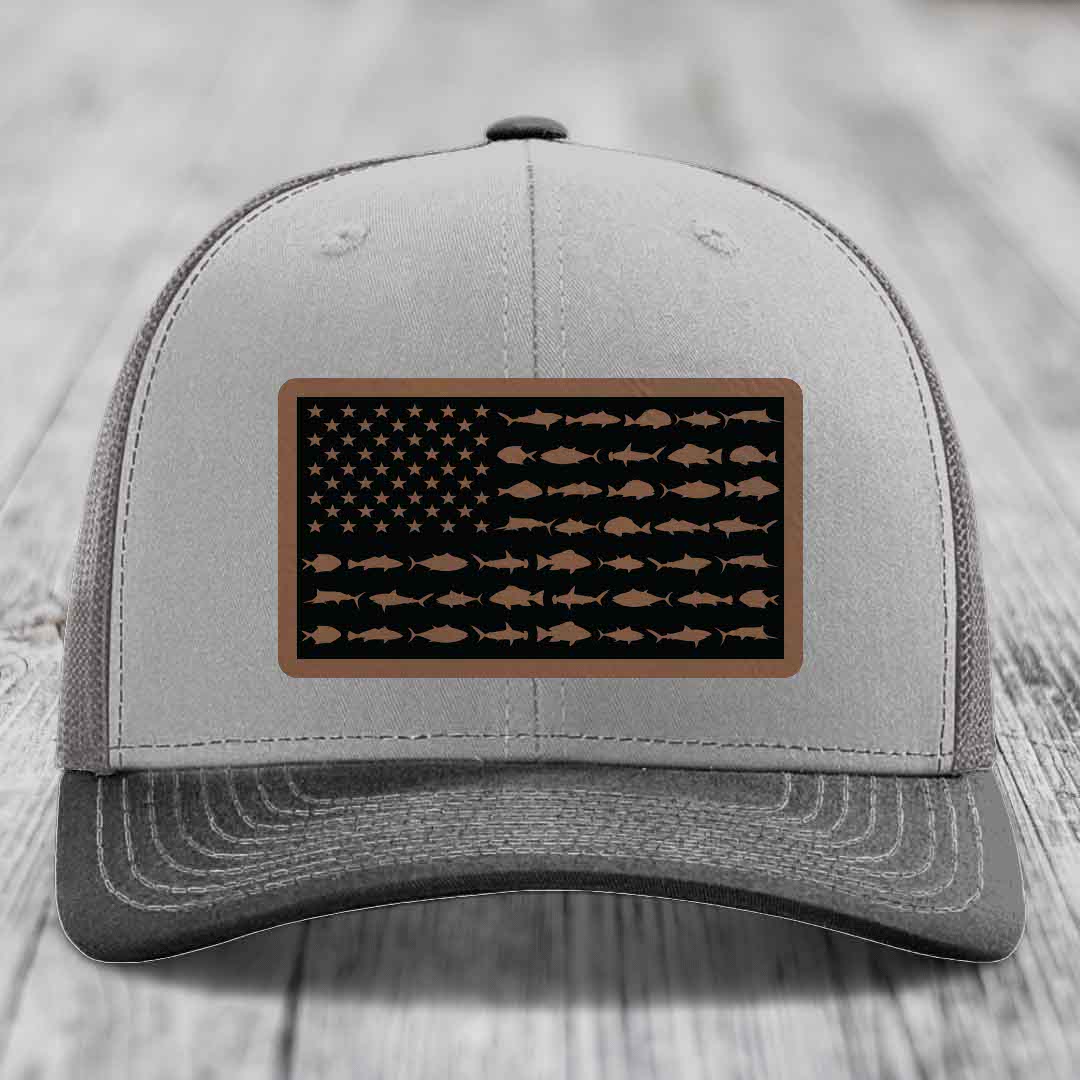 Grey trucker hat with a rectangular patch featuring an American flag design made of fish silhouettes.