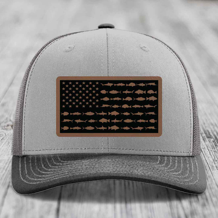 Grey trucker hat with a rectangular patch featuring an American flag design made of fish silhouettes.