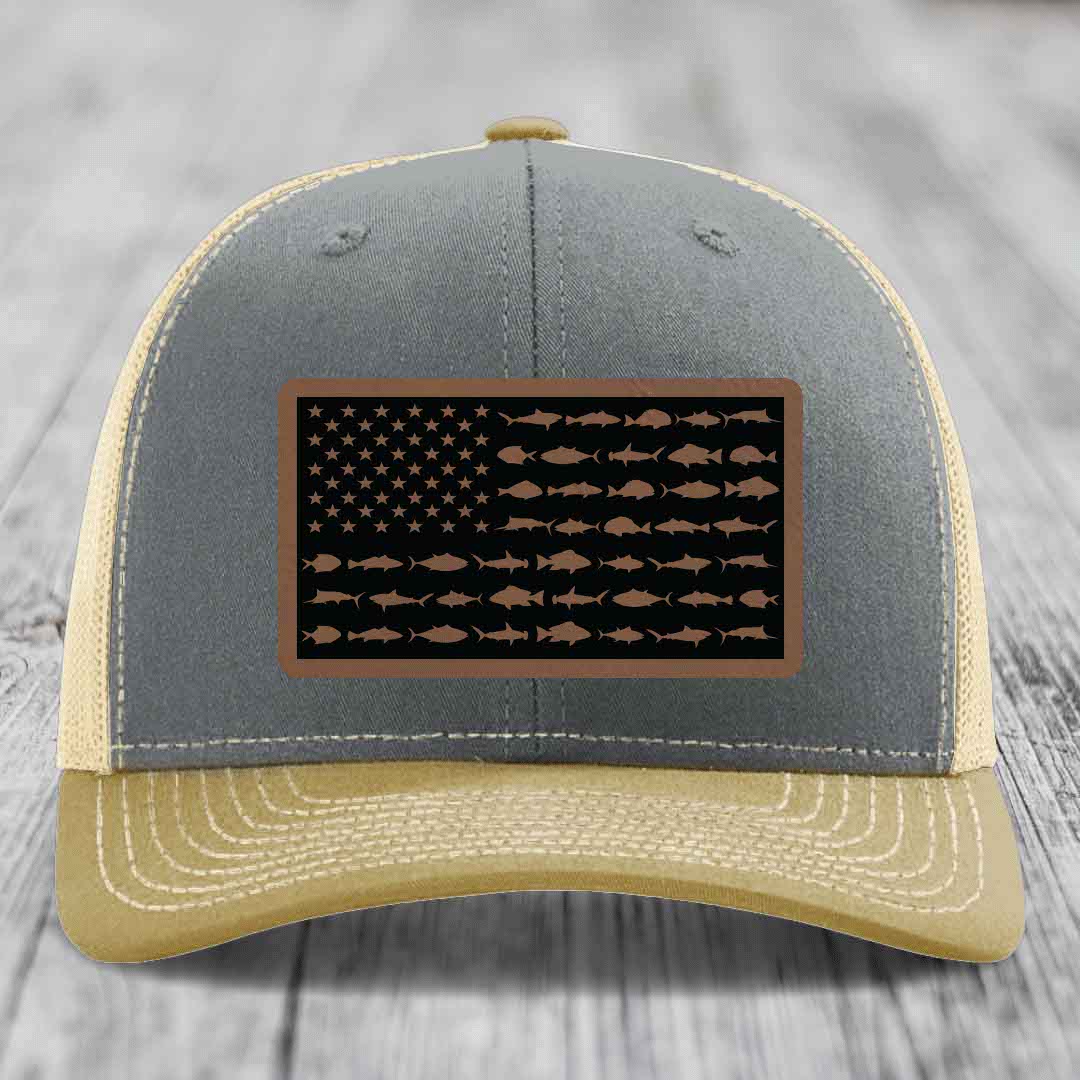 Grey and tan trucker hat with American flag patch made of fish silhouettes.