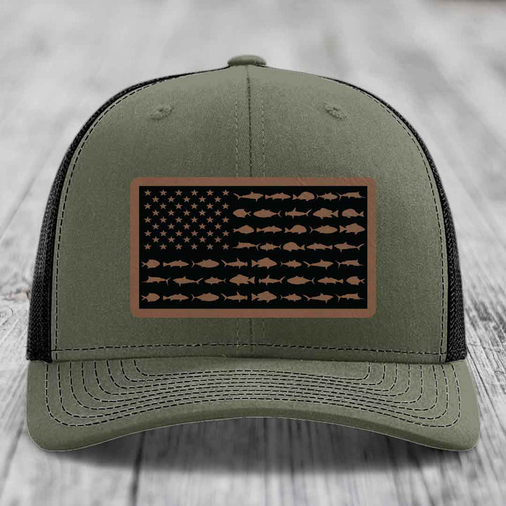 Olive green trucker hat with American flag patch featuring fish silhouettes instead of stars and stripes.
