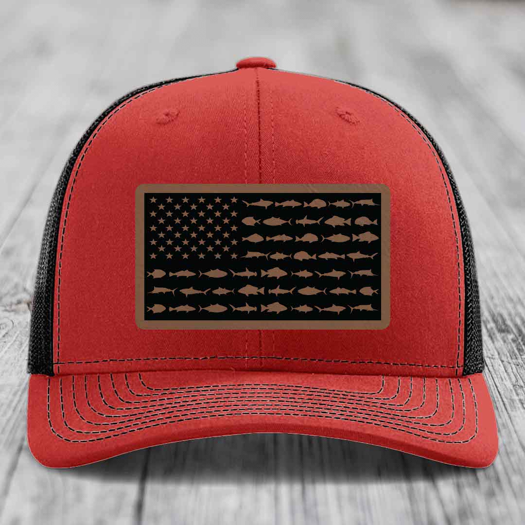 Red trucker hat with black mesh back and a rectangular patch featuring an American flag design made of fish silhouettes.