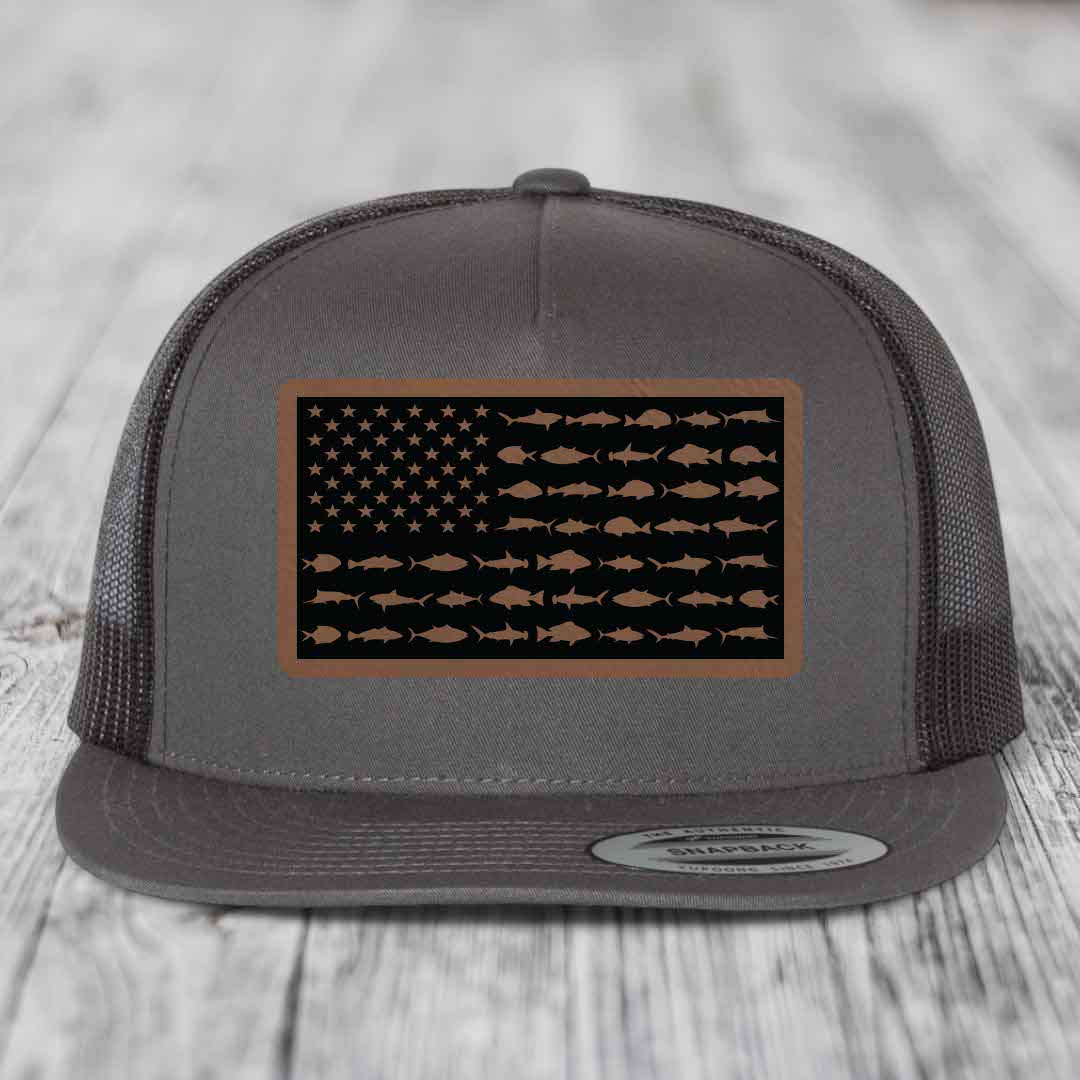 Grey trucker hat with a brown leather patch featuring an American flag design made of fish silhouettes.