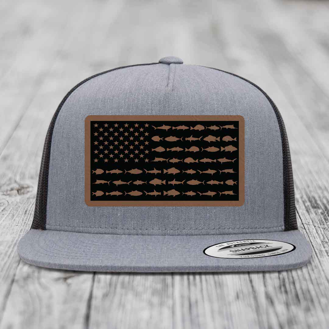 Grey trucker hat with a rectangular patch featuring an American flag design made of fish silhouettes in brown on black background.