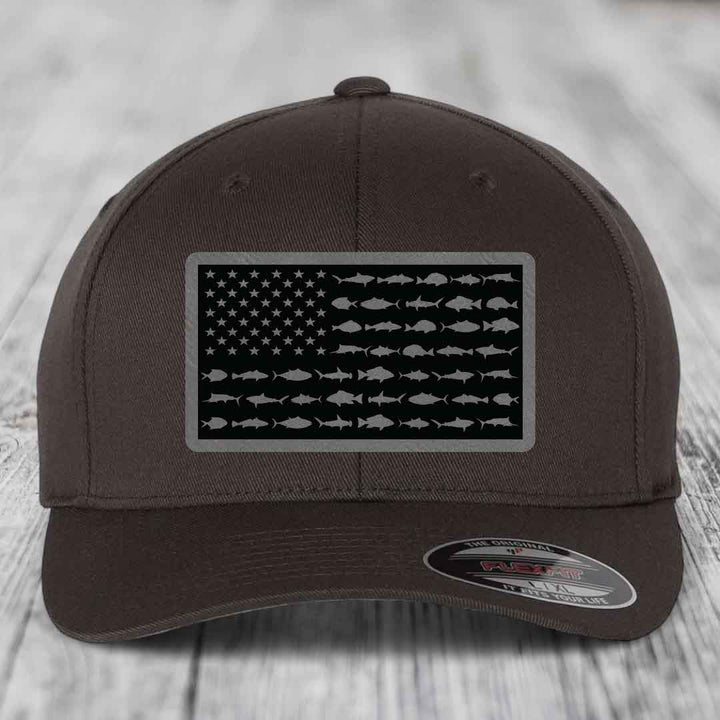 Brown baseball cap with American flag patch featuring fish silhouettes instead of stars and stripes.