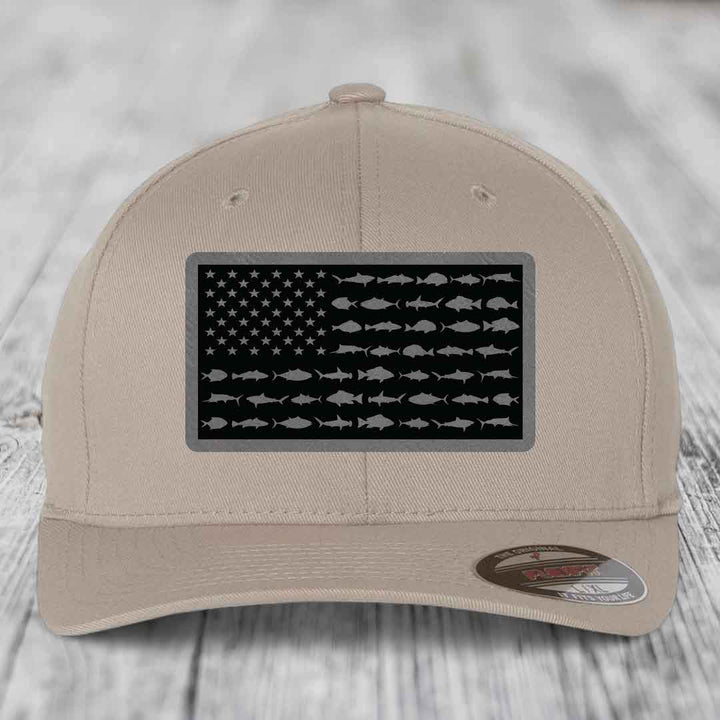 Beige baseball cap with black American flag patch featuring fish silhouettes instead of stars and stripes.