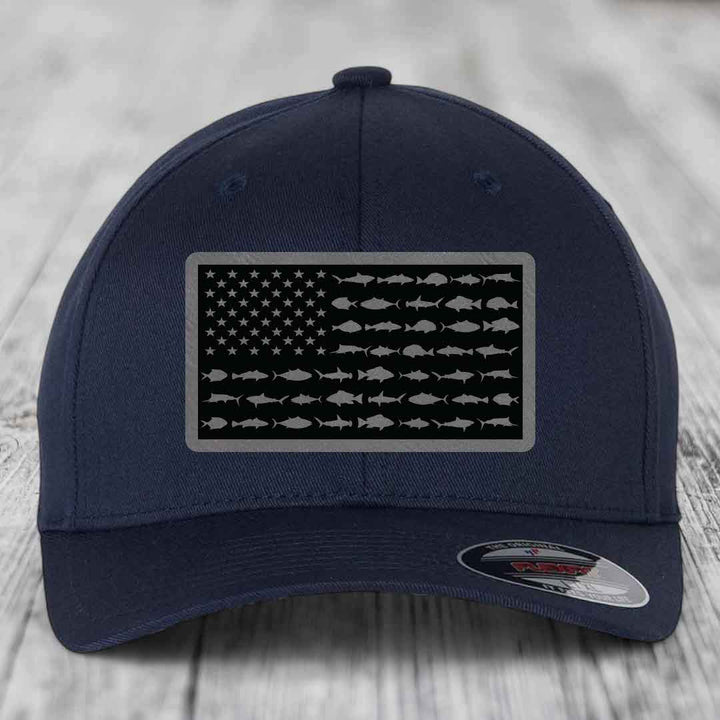 Dark blue baseball cap with American flag patch made of saltwater fish silhouettes.